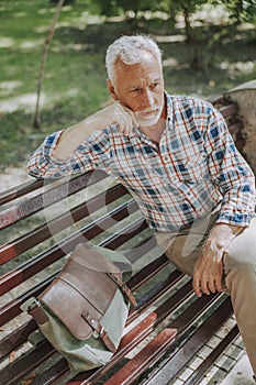 Serious man in the park looking away stock photo