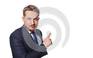 Serious man pointing away while standing against white background