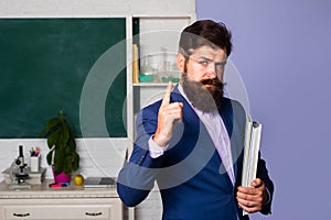 Serious man teacher professor teaching student in classroom. Portrait of confident caucasian male teacher in classroom