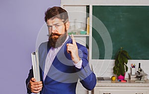 Serious man teacher professor teaching student in classroom. Portrait of confident caucasian male teacher in classroom