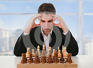 Serious man thinks on game of chess