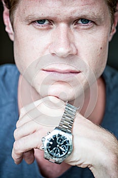 Serious man with watch