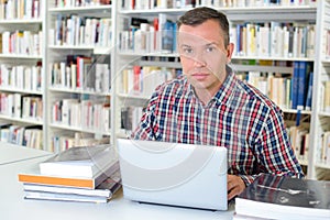 Serious man working in library