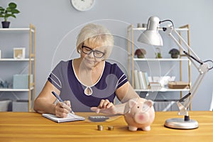 Serious mature lady doing her accounts, planning budget or analyzing pension plan