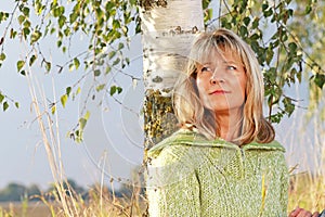 Serious mature woman relaxing in nature