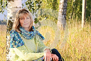 Serious mature woman relaxing in nature