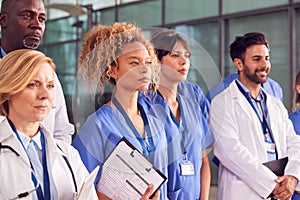 Serious Medical Team Standing In Modern Hospital Building