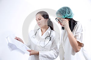 Serious medical workers looking at documentation