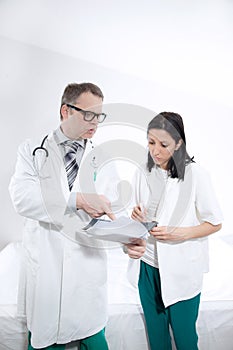 Serious medical workers looking at documentation