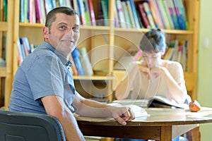serious man working in library