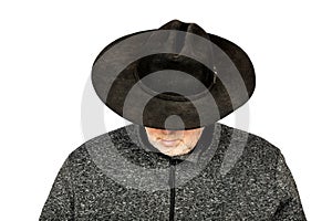 Serious Middle-Aged Caucasian Man in Dirty Black Cowboy Hat Looking Down on White Background