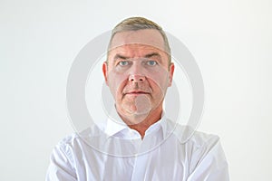 Serious middle-aged man with deadpan expression photo