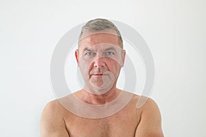 Serious middle-aged man posing shirtless