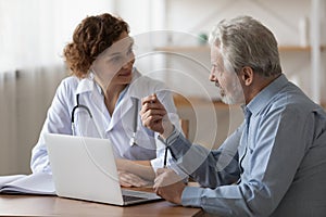 Serious middle aged retired man consulting with physician.