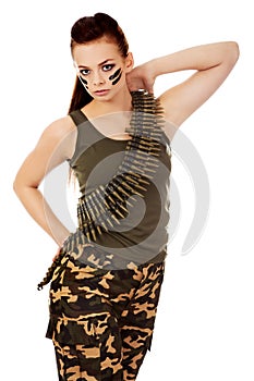 Serious military woman with bullet belt