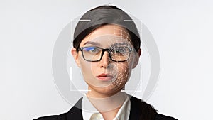 Serious millennial caucasian business woman in glasses and smart technology for face recognition