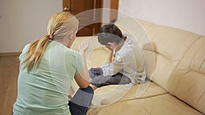 Serious mother lecturing unpleased teenager in home