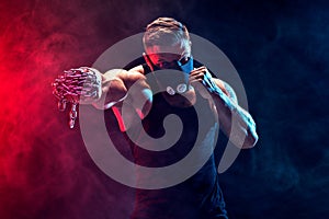 Serious muscular fighter doing the punch with the chains braided over his fist.