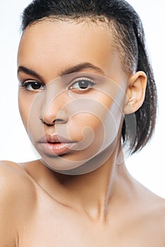 Serious Negroid young woman posing in the studio