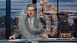 Serious newsreader speaking newscast evening studio closeup. Man broadcasting