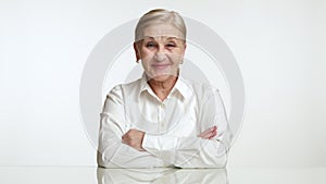 Serious nice elegant aged woman changing her mood into smiling and laughing