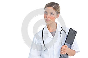 Serious nurse holding clipboard