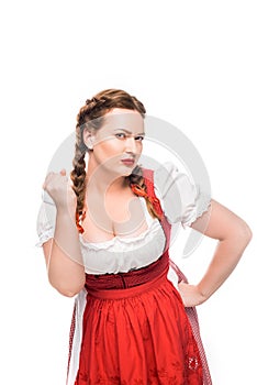 serious oktoberfest waitress in traditional bavarian dress threatening by fist