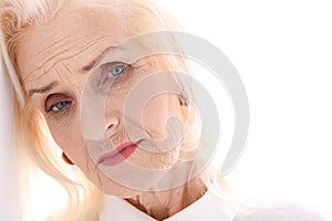 Serious old lady glancing attentively photo