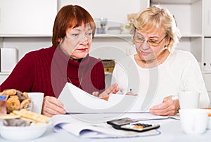 Serious old women with public utilities