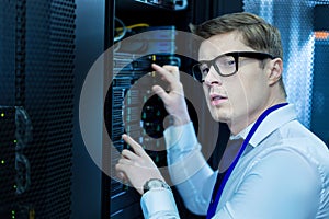 Serious operator working in a data center