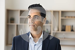 Serious pensive CEO man in formal suit posing in office