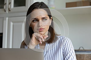 Serious pensive millennial business professional woman distracting from work