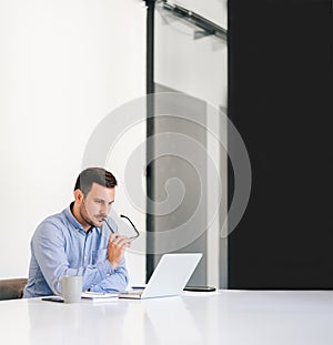 Serious pensive stressed out businessman entrepreneur in office making important online video chat conference call about serious