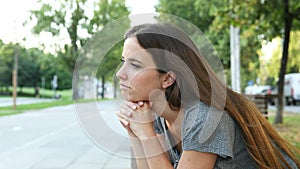 Serious pensive woman contemplating in the street