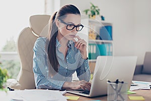 Serious pensive young business lady economist is thinking which