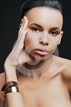 Serious pleasant woman wearing a golden bracelet