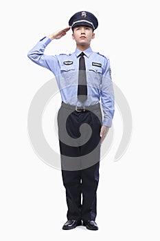 Serious Police Officer Saluting, Studio Shot, full length