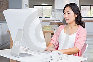 Serious pregnant woman using computer