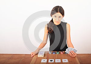 Serious pretty girl - kid playing poker with money