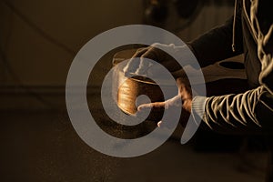 Serious professional guitar-maker working with unfinished guitar at workshop