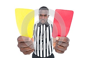 Serious referee showing yellow and red card