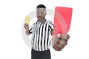 Serious referee showing yellow and red card