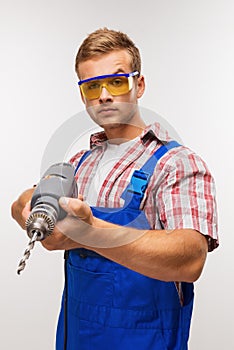 Serious repairman with drill