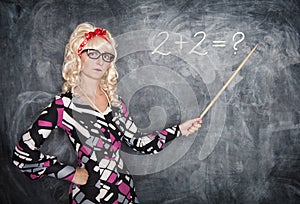 Serious retro teacher in glasses with pointer