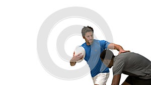 Serious rugby players tackling for ball
