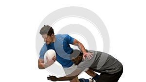 Serious rugby players tackling for ball