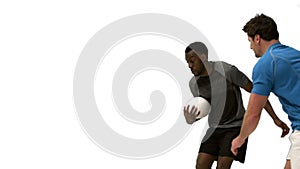 Serious rugby players tackling for ball