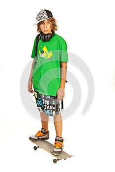 Serious schoolboy teen on skateboard