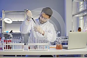 Serious scientist working alone in a pharma or biotech company science laboratory