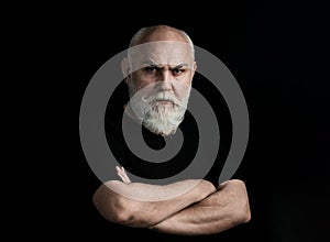 Serious Senior Man looking at camera isolated on black. Closeup low key studio portrait of gray hair old man looking at